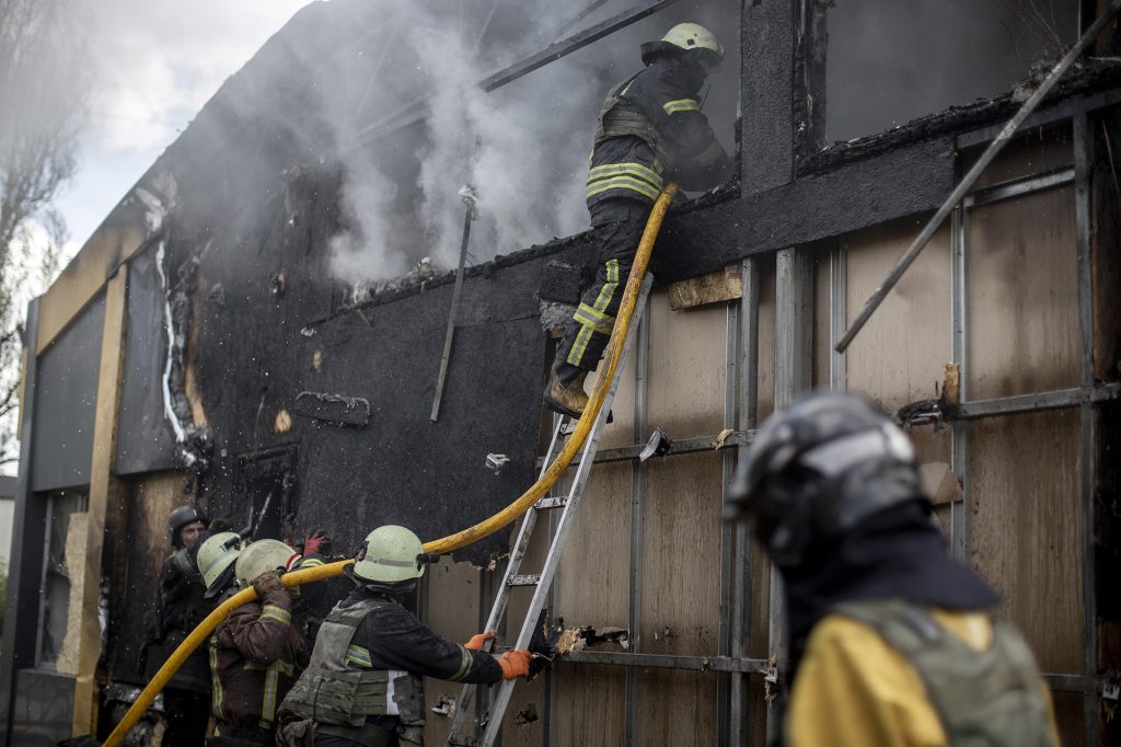 Firefighters work to extinguish a fire in a commercial area following a rocket attack in the Saltivka area of  Kharkiv, Ukraine, on April 26.
