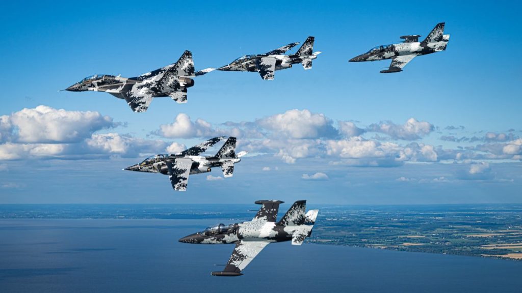 Polaris Dawn crew members do high-performance jet training as a part of the EAA AirVenture Oshkosh air show in July 2022.